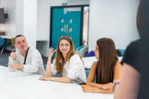 Marketing apprentices talking in a classroom
